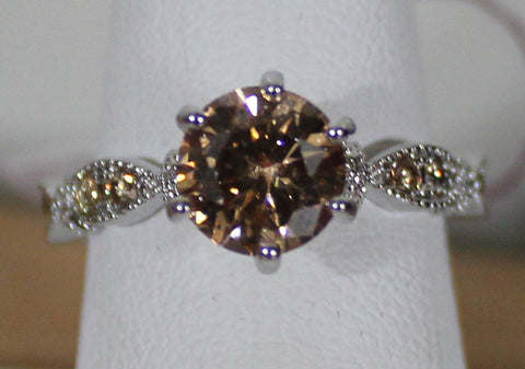W00321 Silvertone Ring With Citrine Colored Center Stone and small stones on band Size 8